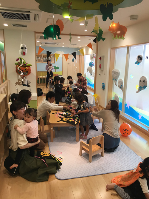 Kids and their parents creating Halloween decorations